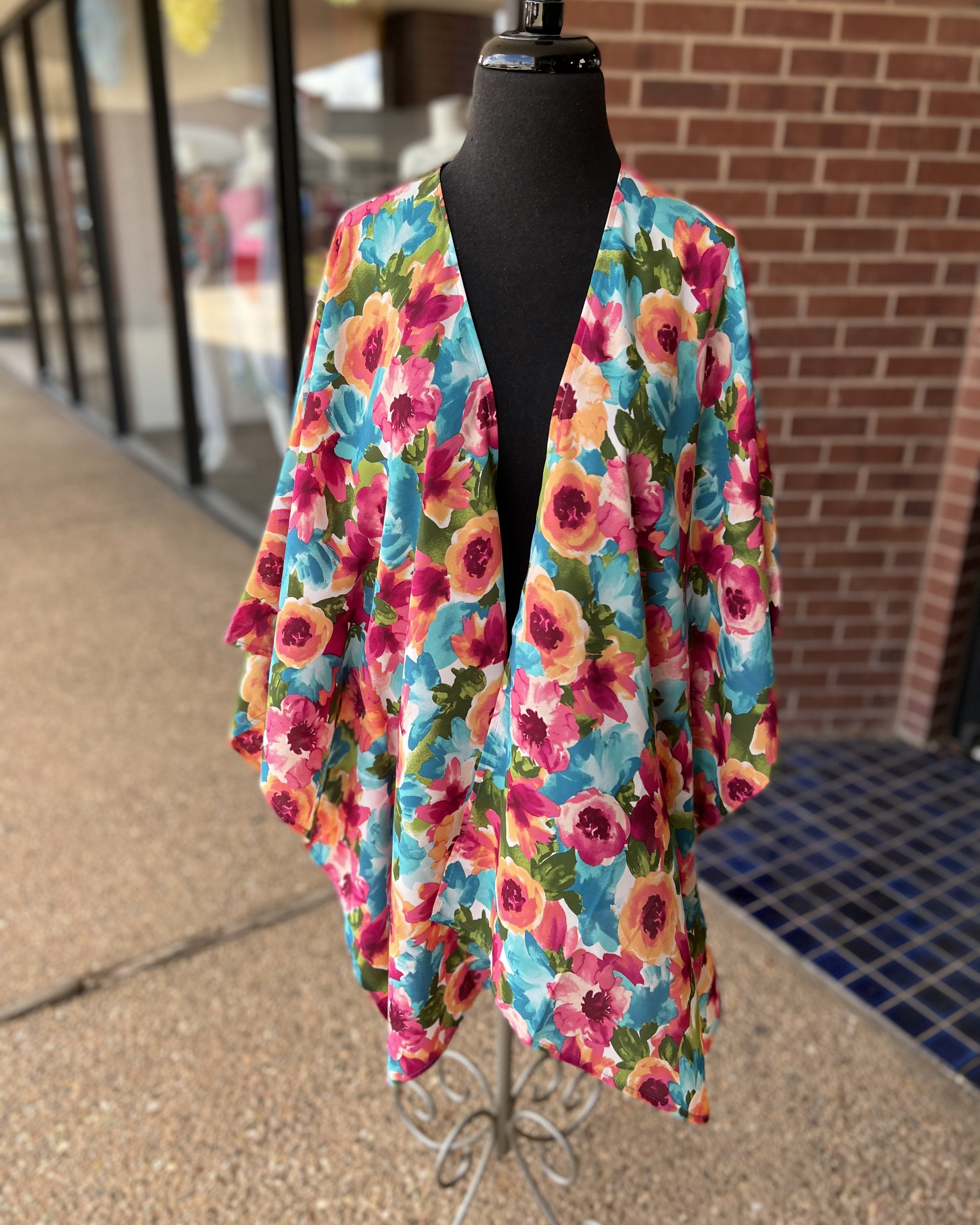 a flowy style open front kimono made of lightweight material with half sleeves on an exclusive vibrant multicolor floral pattern fabric