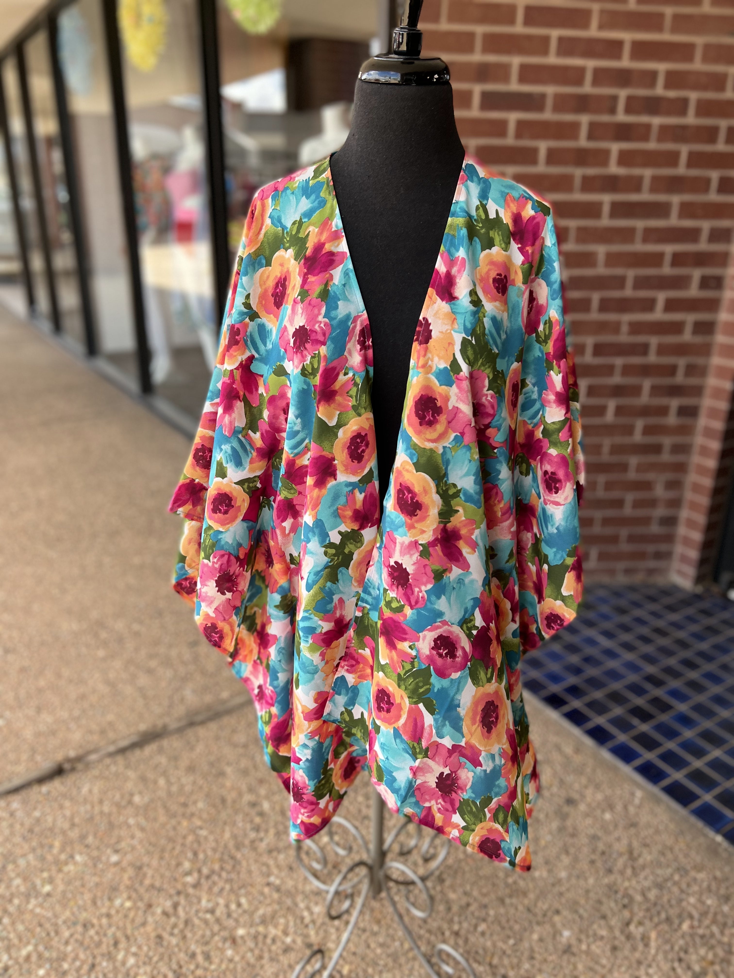 a flowy style open front kimono made of lightweight material with half sleeves on an exclusive vibrant multicolor floral pattern fabric