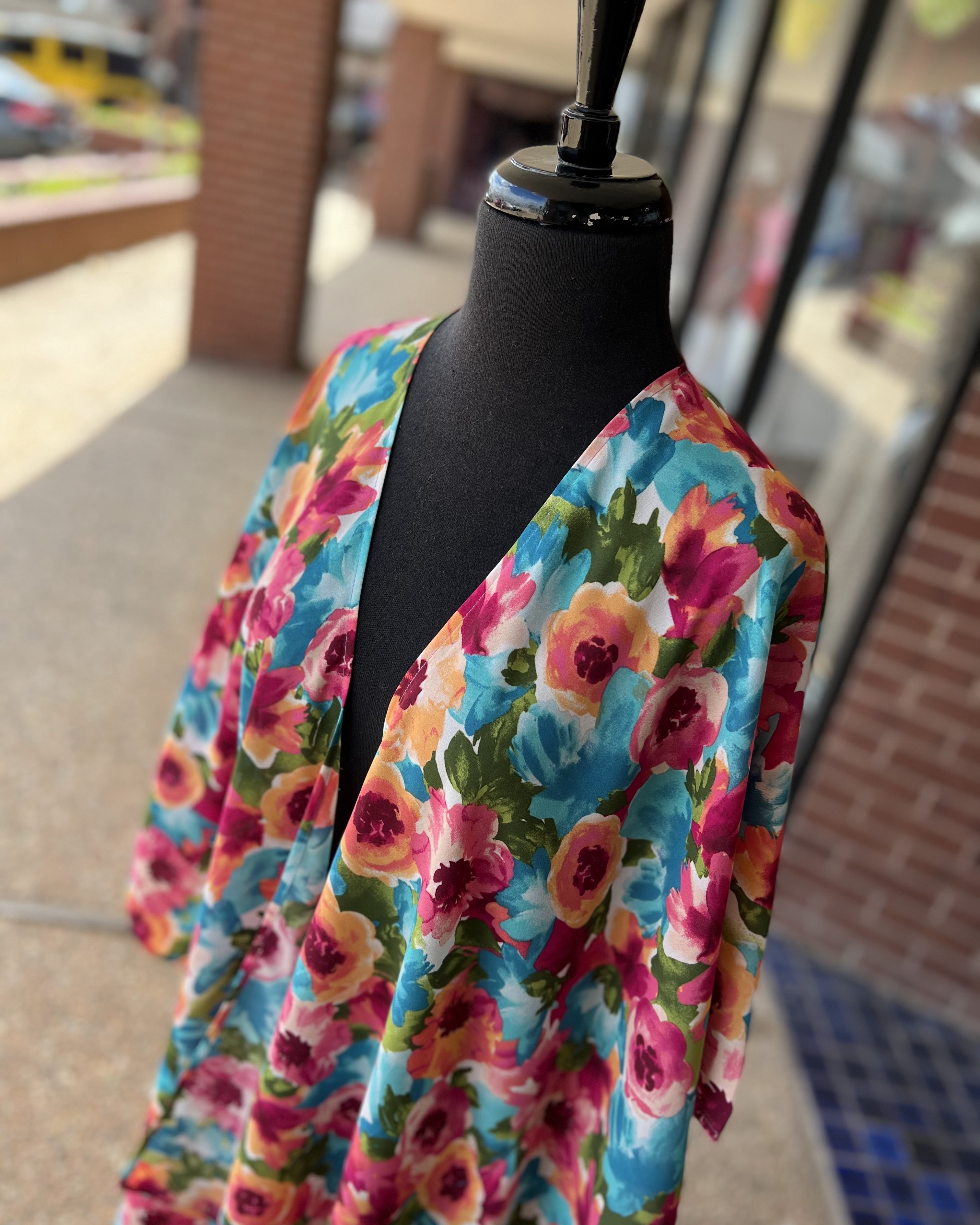 a flowy style open front kimono made of lightweight material with half sleeves on an exclusive vibrant multicolor floral pattern fabric