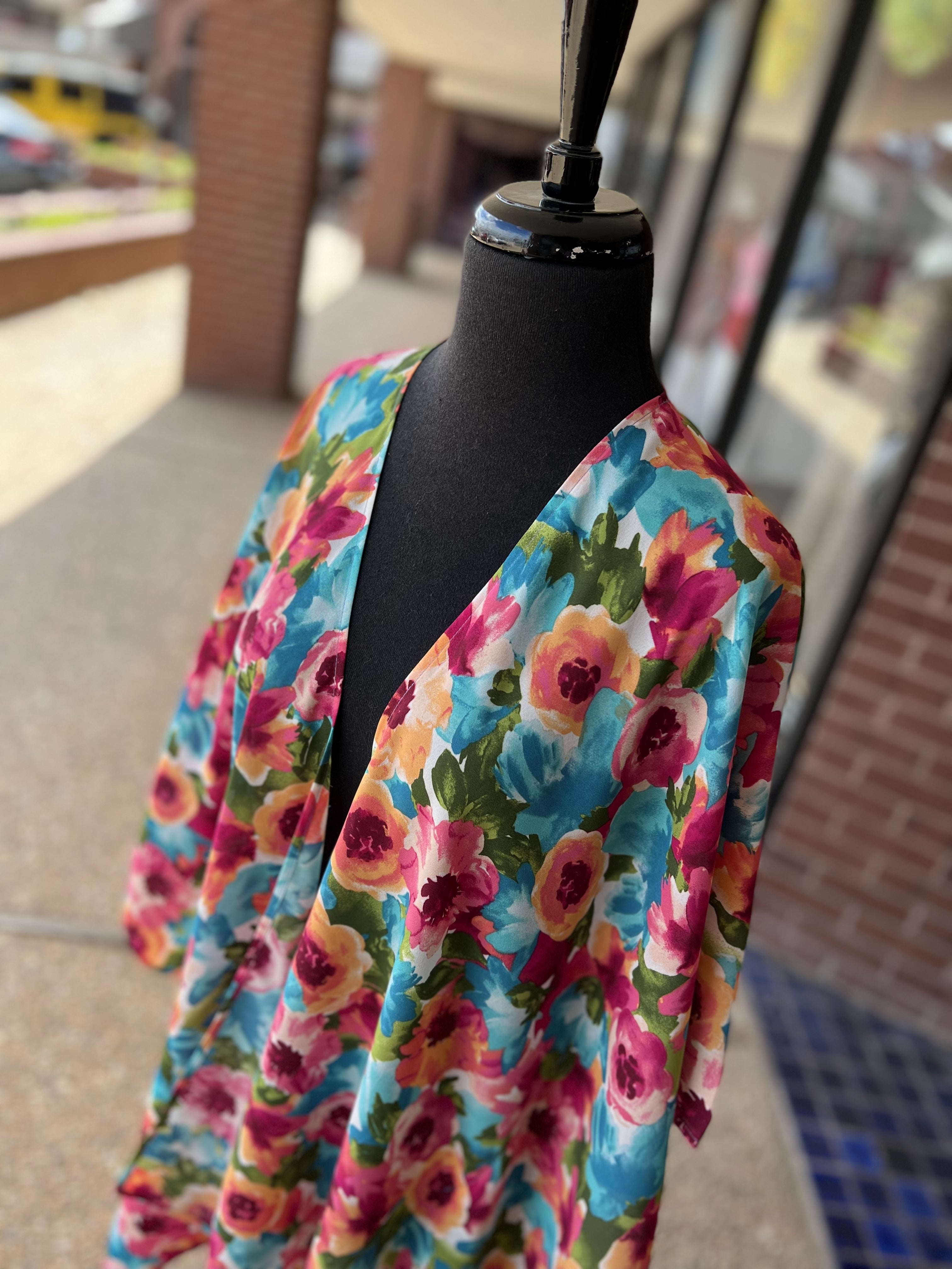 a flowy style open front kimono made of lightweight material with half sleeves on an exclusive vibrant multicolor floral pattern fabric