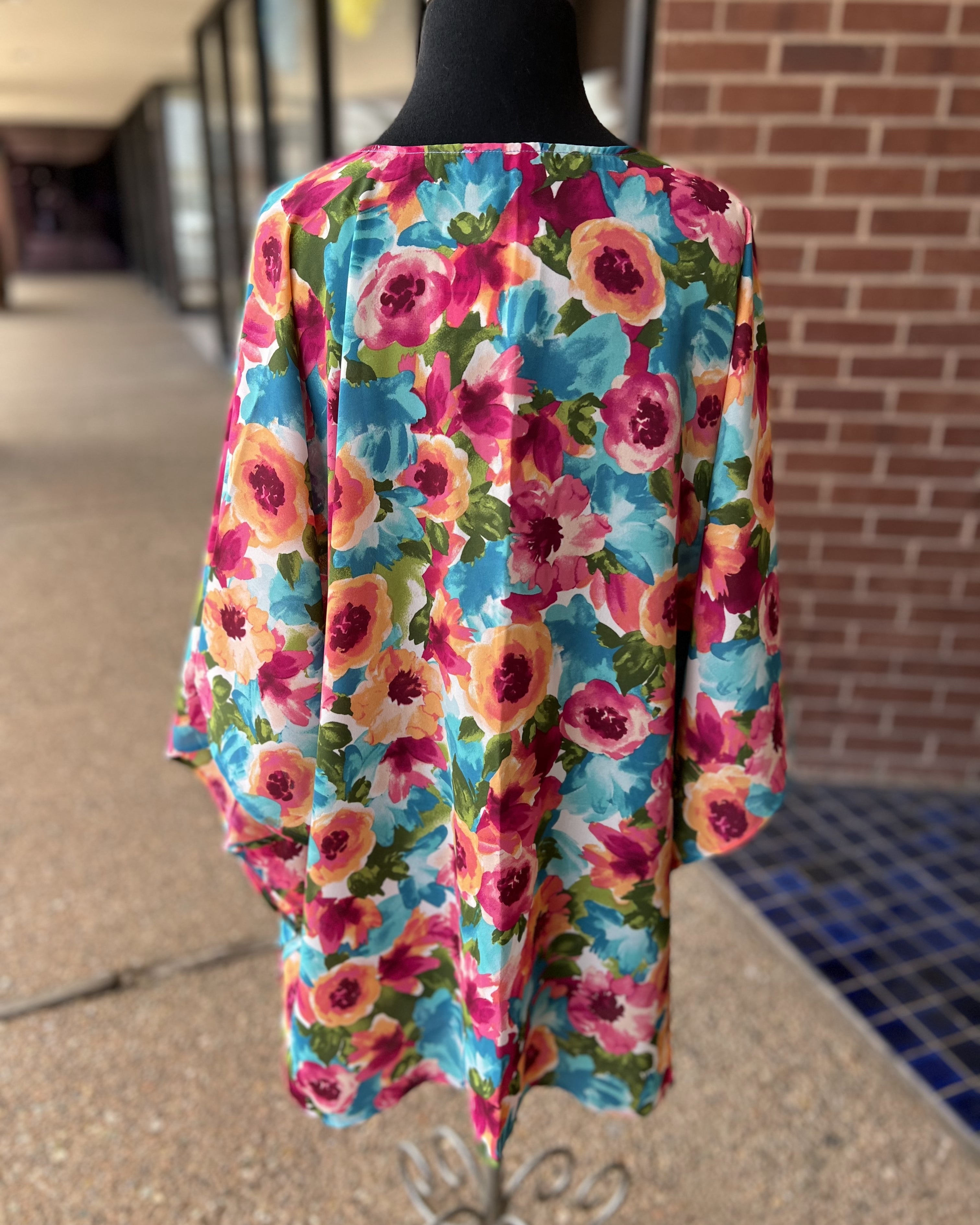 a flowy style open front kimono made of lightweight material with half sleeves on an exclusive vibrant multicolor floral pattern fabric