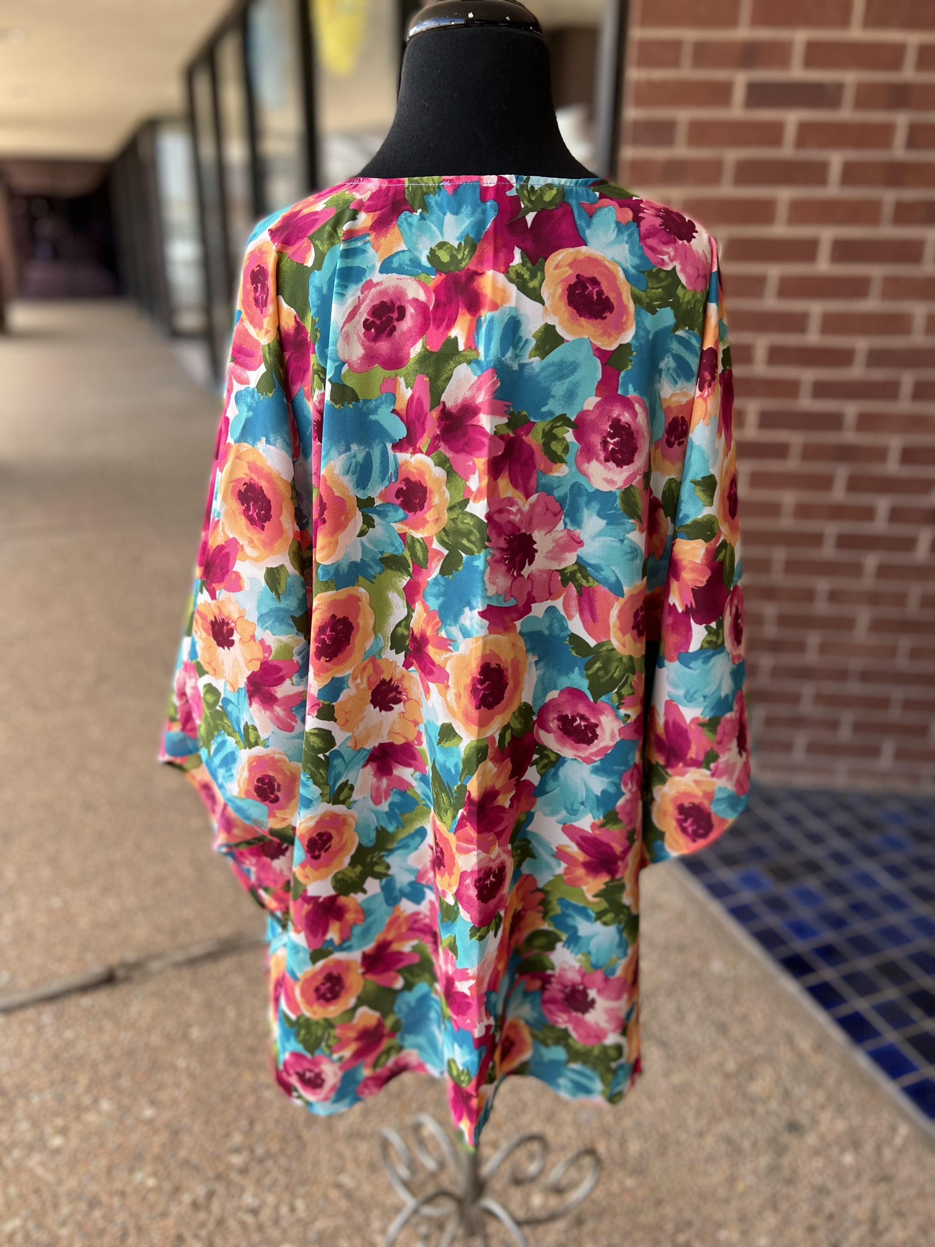 a flowy style open front kimono made of lightweight material with half sleeves on an exclusive vibrant multicolor floral pattern fabric