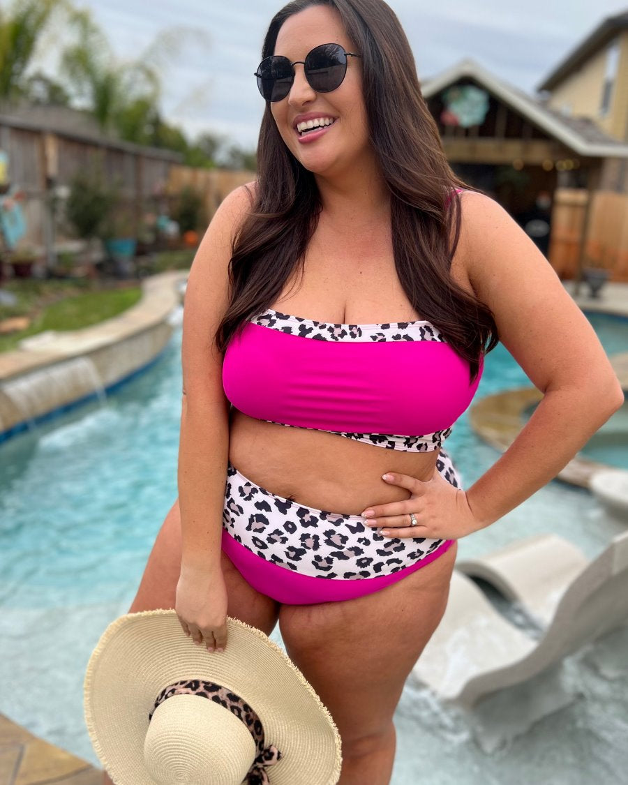two-piece swimsuit made of stretchy material with a square neckline, adjustable spaghetti straps, and removable padding paired with high-waisted bottoms on a hot pink fabric and a leopard print trim 