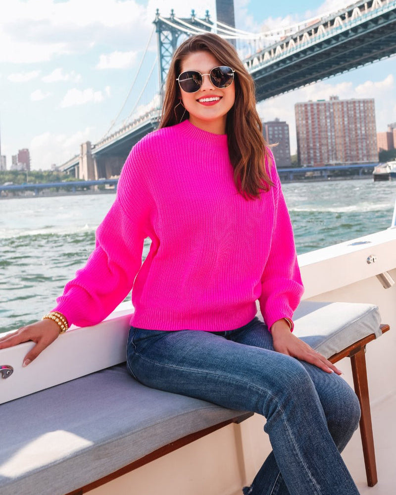 a pink long sleeve sweater with a drop-shoulder for a relaxed fit, a crew neckline, and a ribbed hemline on a textured ultra-soft design fabric