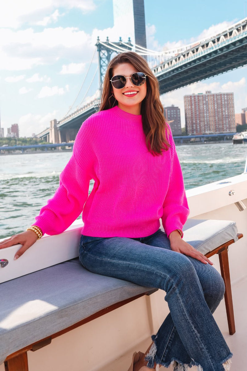 a pink long sleeve sweater with a drop-shoulder for a relaxed fit, a crew neckline, and a ribbed hemline on a textured ultra-soft design fabric