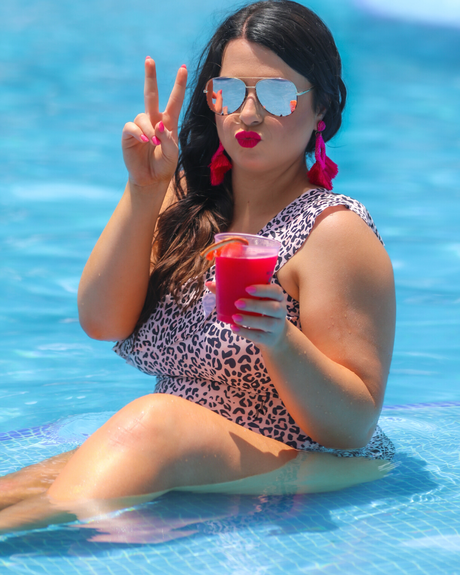 stretchy one-piece with one-shoulder ruffled neckline and removable padding on a black and neutral leopard pattern print fabric