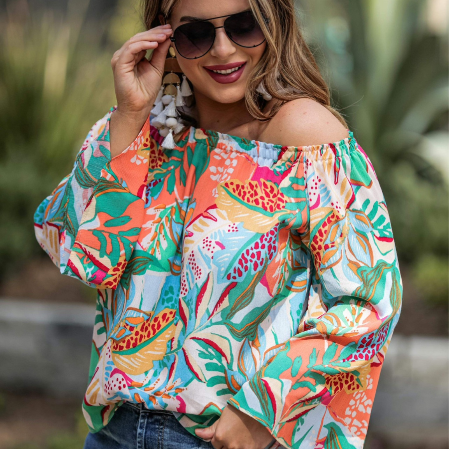 off-the-shoulder flowy top with an elastic neckline in a vibrant floral pattern in ivory