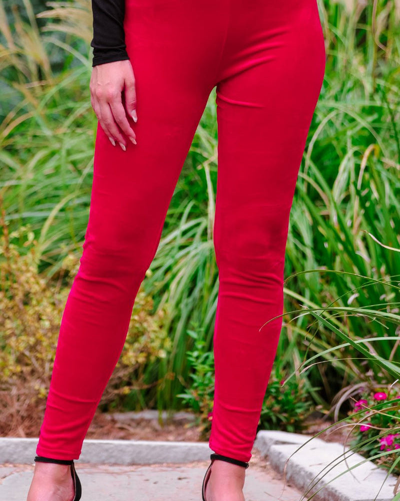 ultra soft stretch leggings crafted from luxurious velvet fabric with an elastic waistband and flattering rise in red