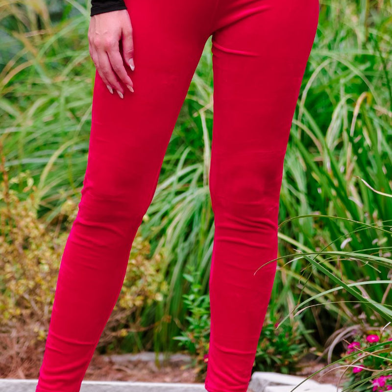 ultra soft stretch leggings crafted from luxurious velvet fabric with an elastic waistband and flattering rise in red