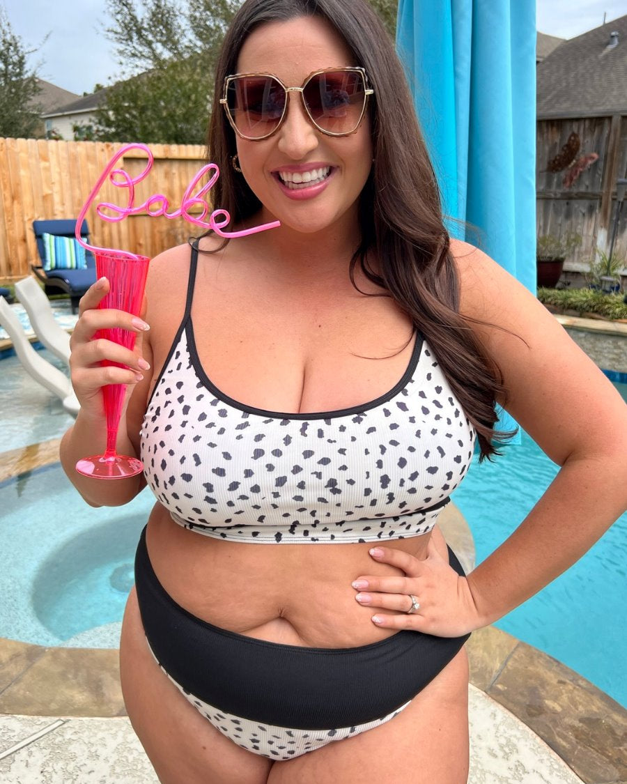 two-piece swimsuit made of lightweight four-way stretchy material and subtle ribbed texturing on a neutral leopard print with a bralette-style top, adjustable spaghetti straps, removable padding, a black band, and flattering form-fitting silhouette paired with high waistline bottoms with a black solid band for added tummy control