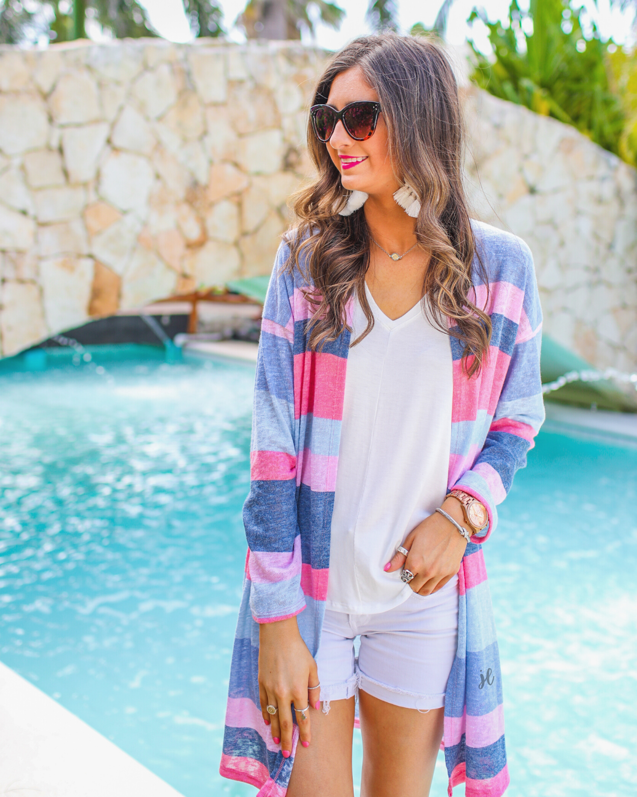 a blue long-sleeve open-front cardigan with a modern drop-shoulder silhouette, bold blue and pink horizontal stripes, and a lightweight relaxed fit