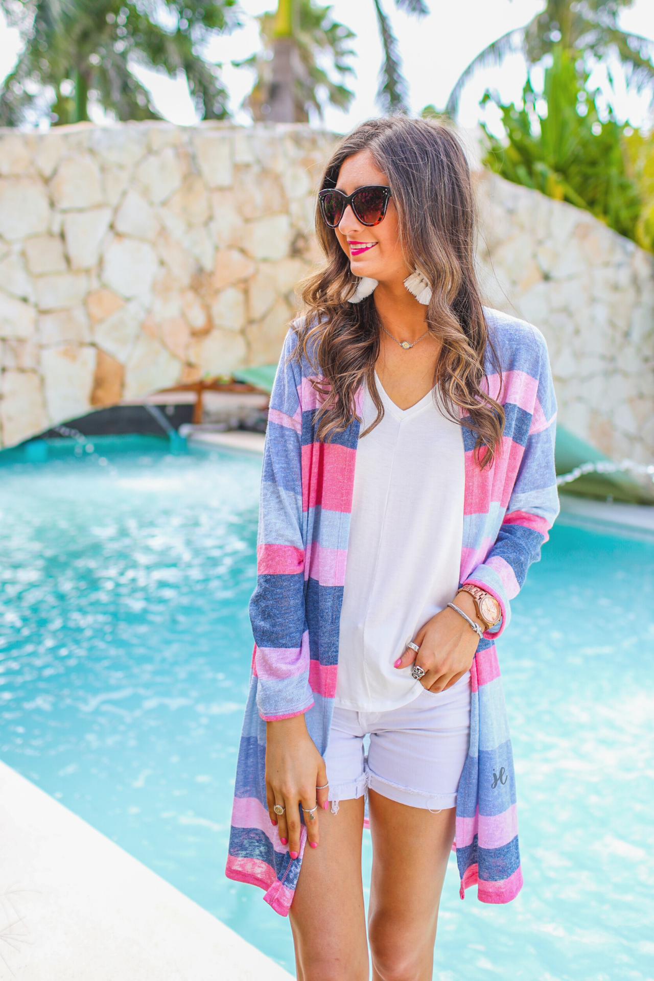 a blue long-sleeve open-front cardigan with a modern drop-shoulder silhouette, bold blue and pink horizontal stripes, and a lightweight relaxed fit