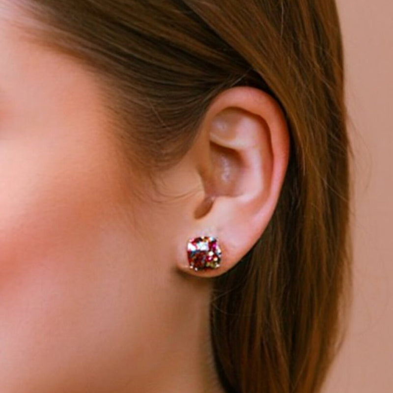 a dainty gold-plated stud earring with glitter sparkles, a comfort replacement earring back with a plastic disk stopper style in multicolor