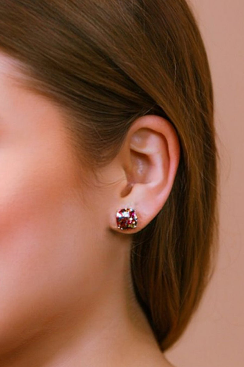 a dainty gold-plated stud earring with glitter sparkles, a comfort replacement earring back with a plastic disk stopper style in multicolor