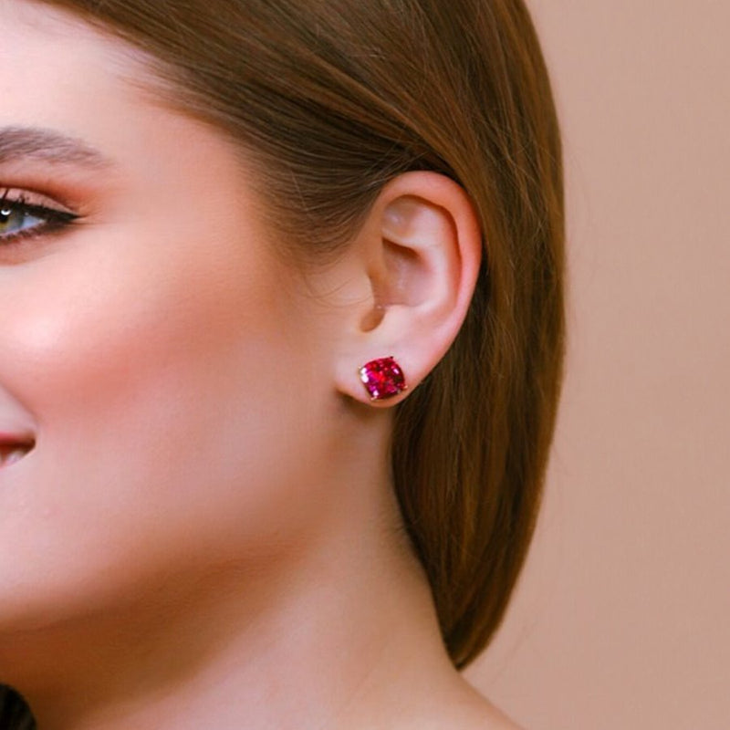 a dainty gold-plated stud earring with glitter sparkles, a comfort replacement earring back with a plastic disk stopper style in hot pink