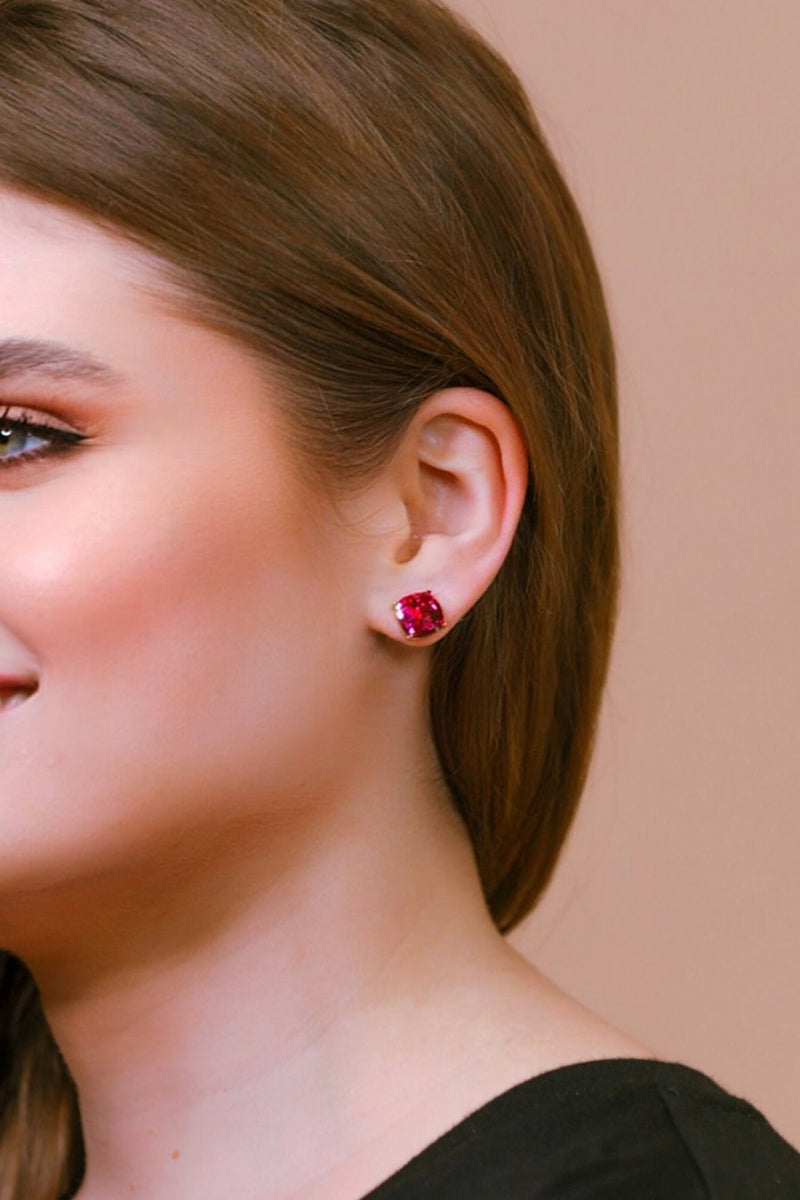 a dainty gold-plated stud earring with glitter sparkles, a comfort replacement earring back with a plastic disk stopper style in hot pink