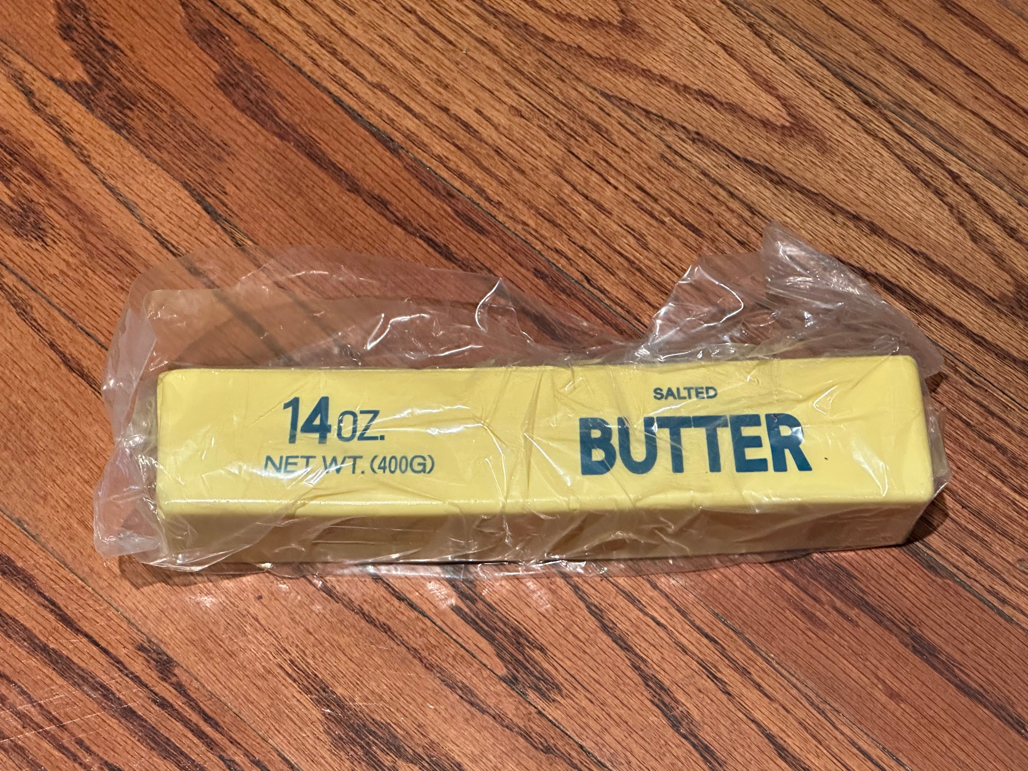 a giant 14oz yellow slow-rising salted butter-stick squishy with realistic labeling, and an oversized shape