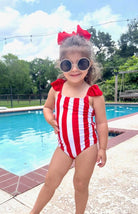 red and white vertical stripe one-piece swimsuit with ruffle sleeves and a criss-cross back