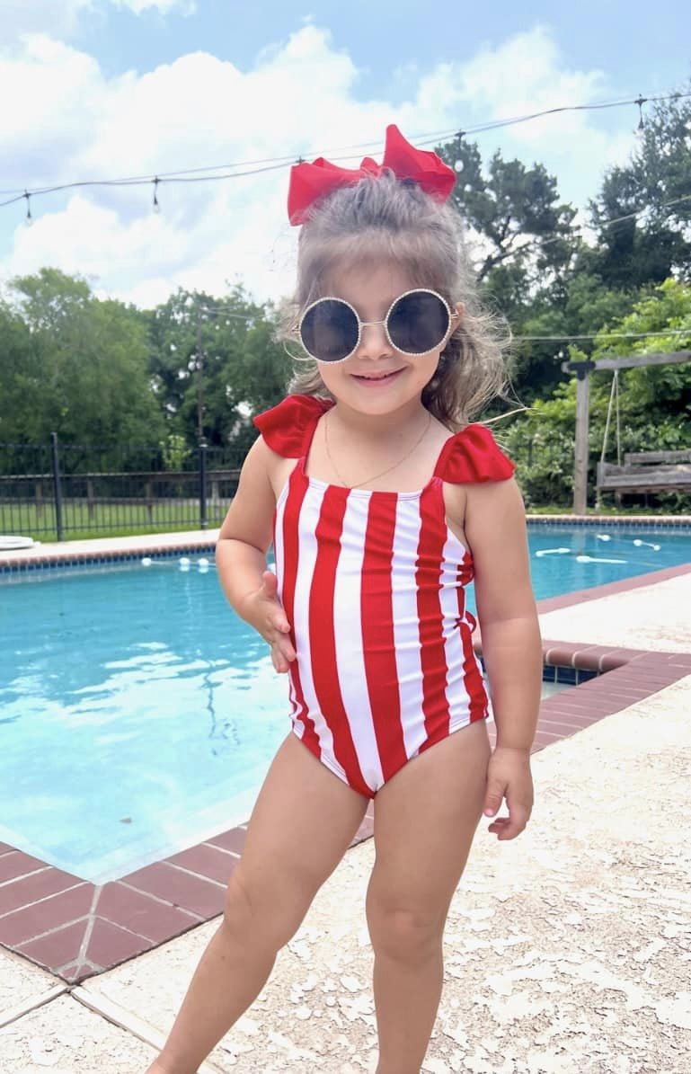 red and white vertical stripe one-piece swimsuit with ruffle sleeves and a criss-cross back