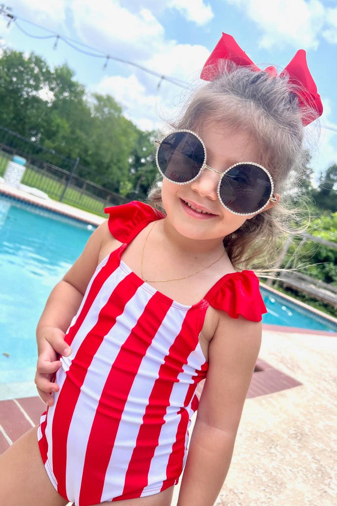 red and white vertical stripe one-piece swimsuit with ruffle sleeves and a criss-cross back