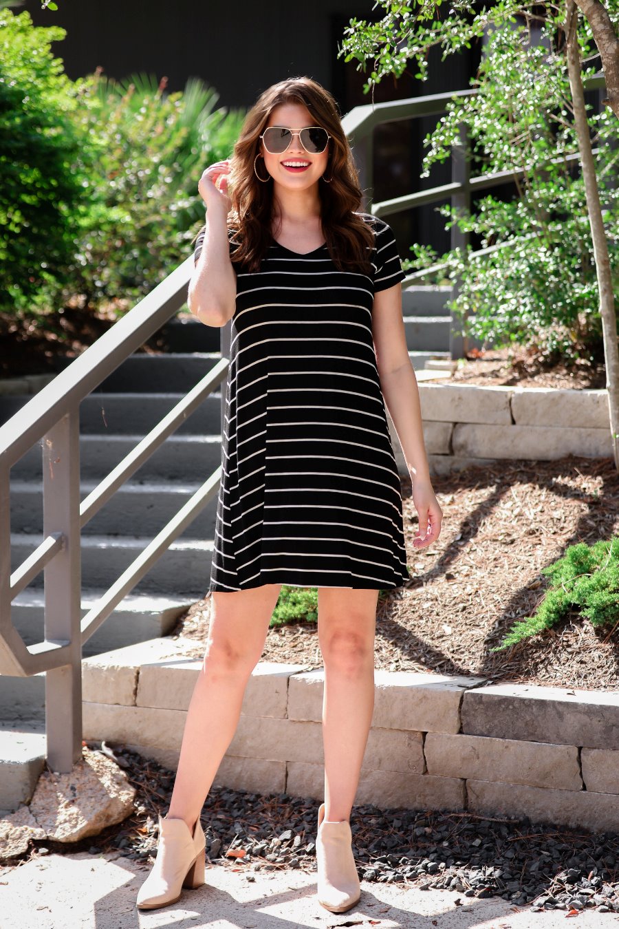 short-sleeve A-line dress with a V-neckline, crafted from ultra-soft fabric in a solid color with horizontal white stripes and a straight hemline in black