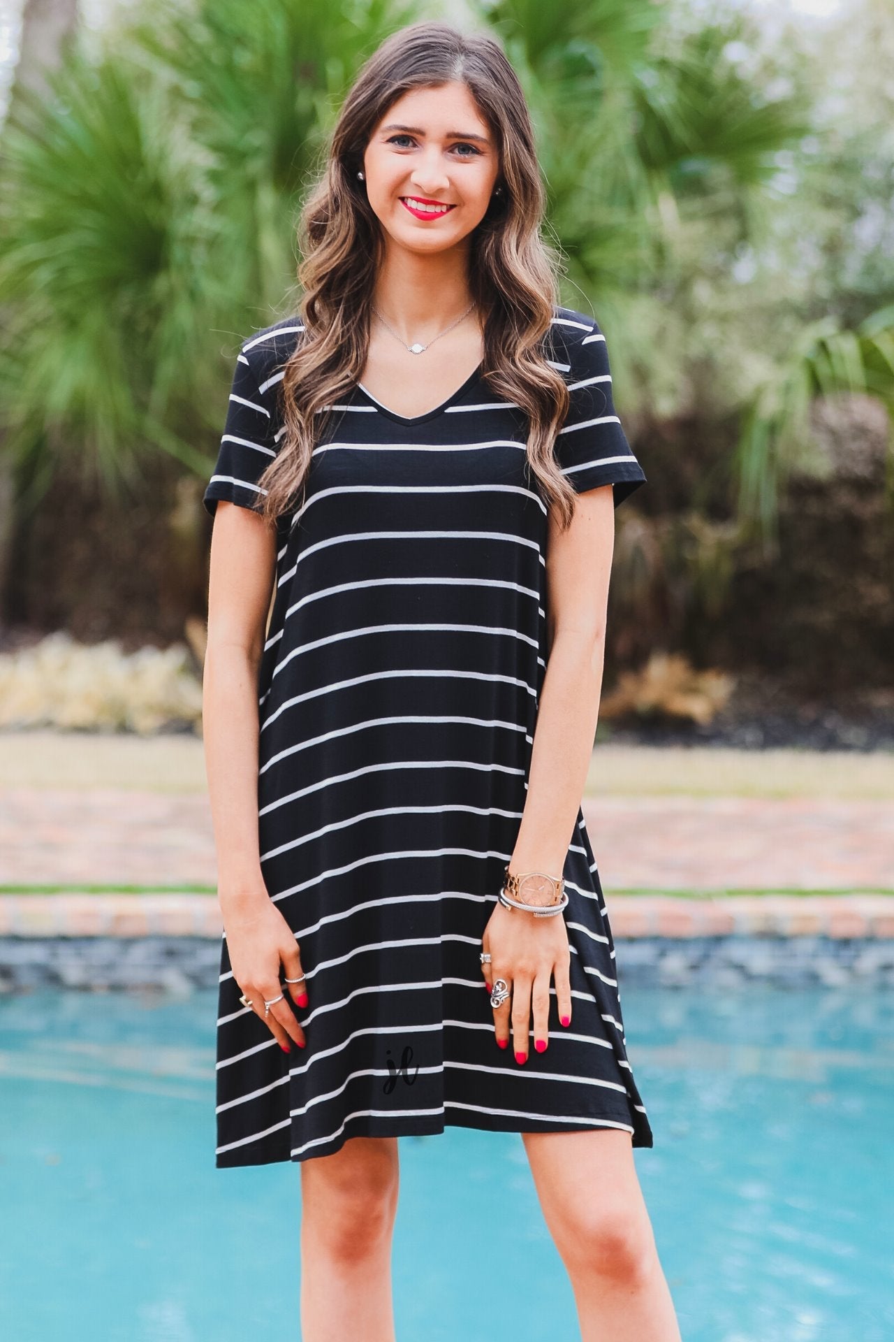 short-sleeve A-line dress with a V-neckline, crafted from ultra-soft fabric in a solid color with horizontal white stripes and a straight hemline in black