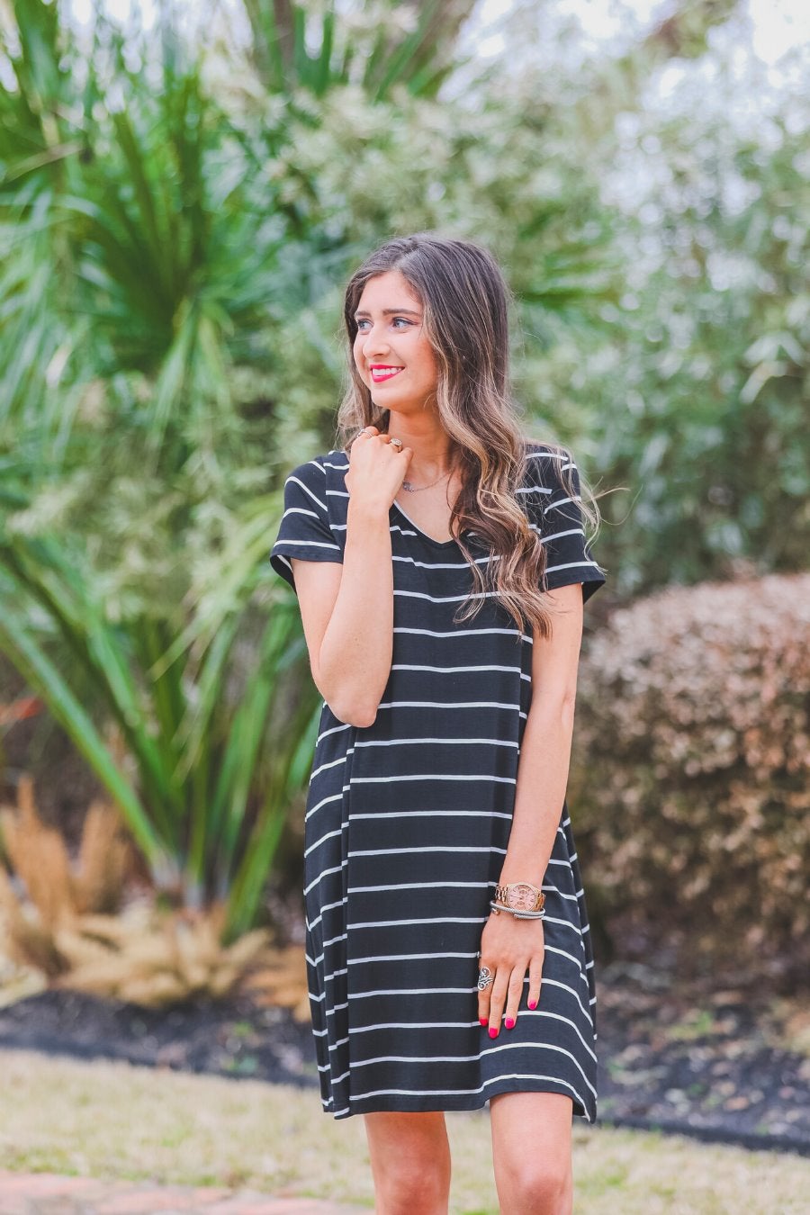 short-sleeve A-line dress with a V-neckline, crafted from ultra-soft fabric in a solid color with horizontal white stripes and a straight hemline in black