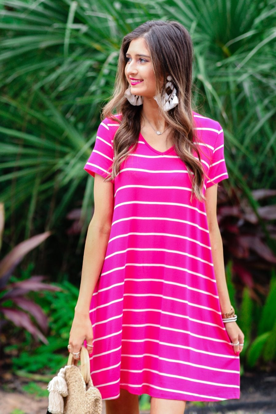 short-sleeve A-line dress with a V-neckline, crafted from ultra-soft fabric in a solid color with horizontal white stripes and a straight hemline in hot pink
