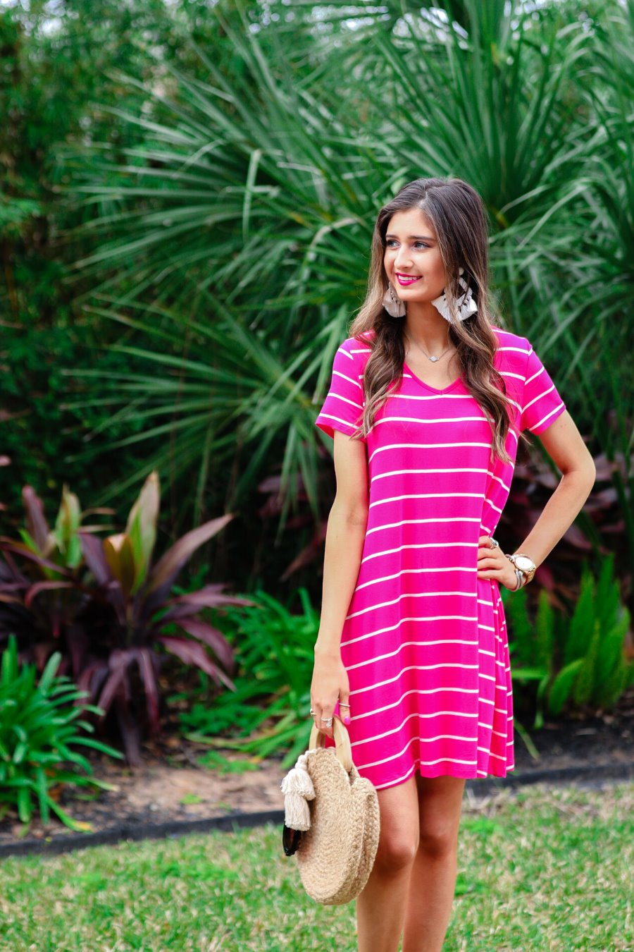 short-sleeve A-line dress with a V-neckline, crafted from ultra-soft fabric in a solid color with horizontal white stripes and a straight hemline in hot pink