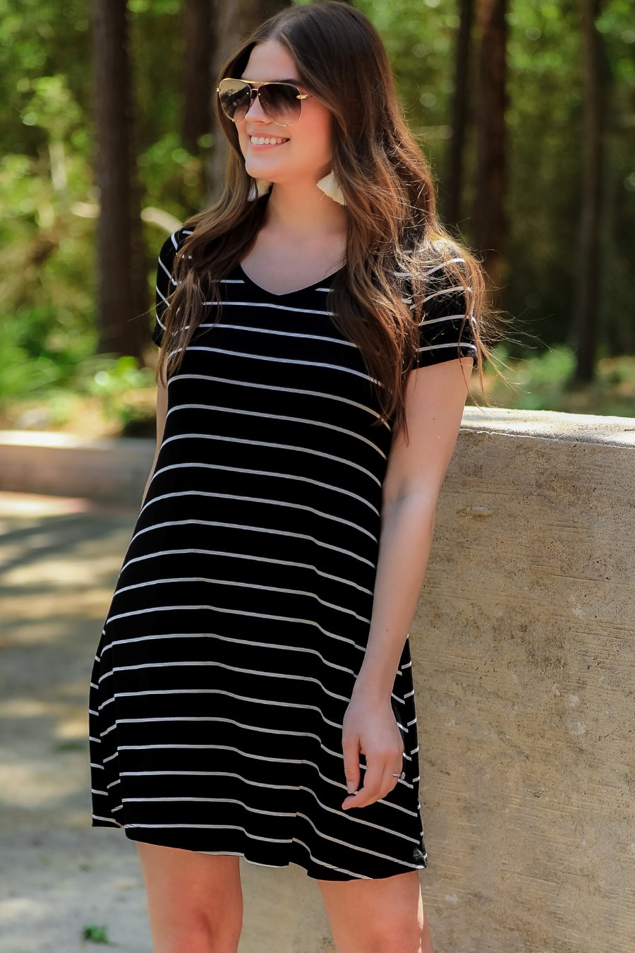 short-sleeve A-line dress with a V-neckline, crafted from ultra-soft fabric in a solid color with horizontal white stripes and a straight hemline in black
