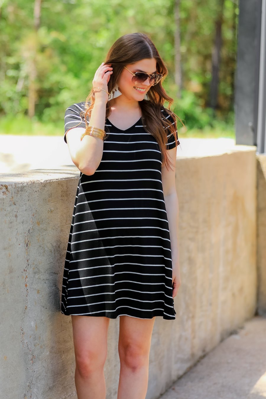 short-sleeve A-line dress with a V-neckline, crafted from ultra-soft fabric in a solid color with horizontal white stripes and a straight hemline in black