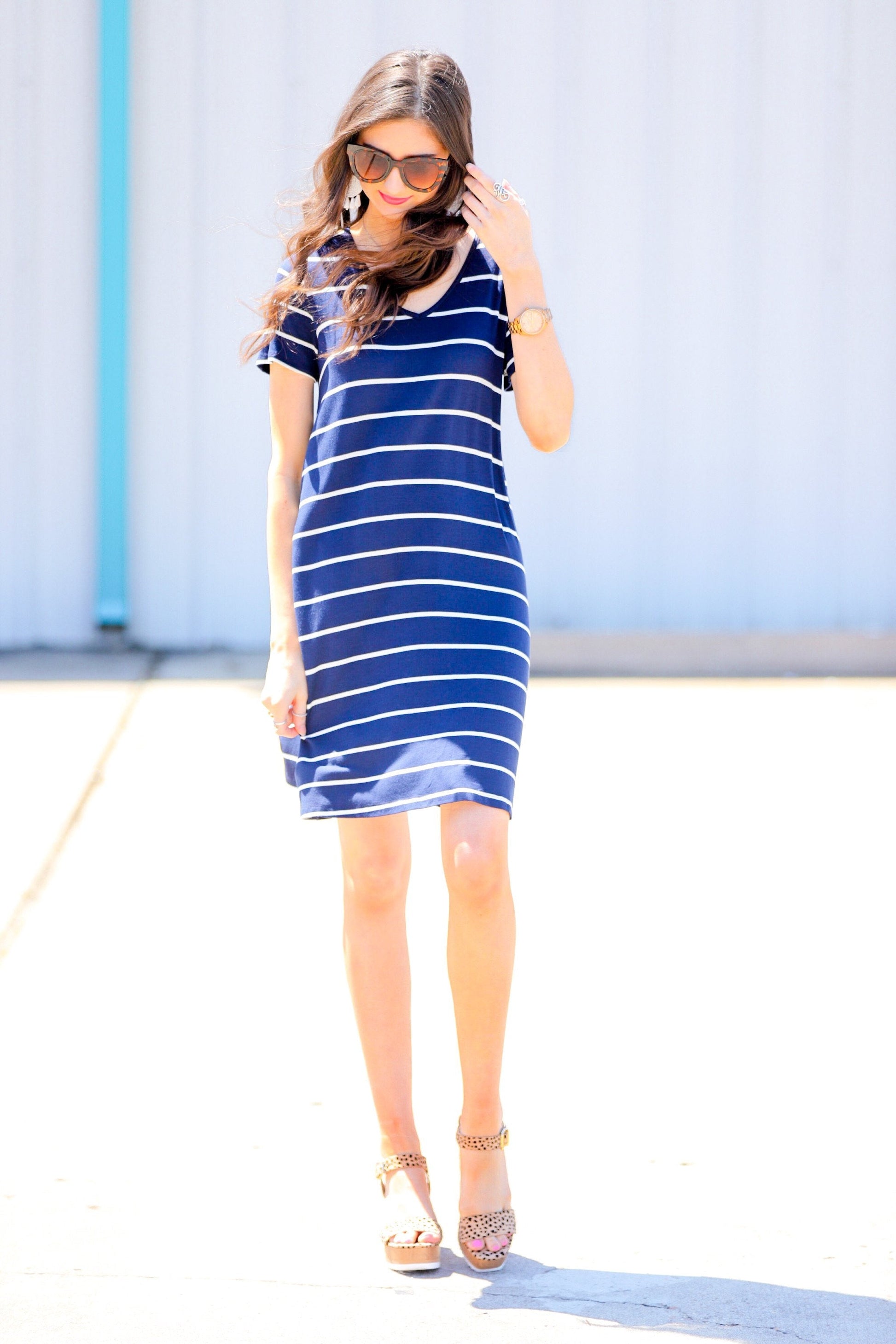 short-sleeve A-line dress with a V-neckline, crafted from ultra-soft fabric in a solid color with horizontal white stripes and a straight hemline in navy