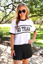 a black pleated tennis skort with built-in shorts, wide comfort waistband, 4-way stretch, and moisture-wicking polyester/spandex blend fabric