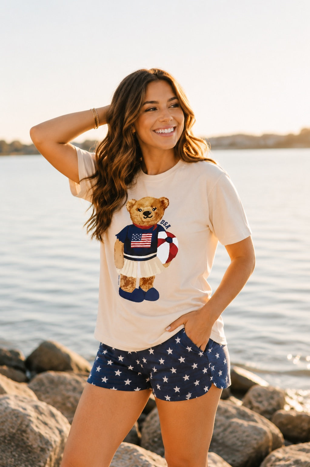 a relaxed-fit beige crew neck tee with a patriotic DTF teddy graphic, short sleeves, standard t-shirt length, unlined construction, and a little stretch that runs large