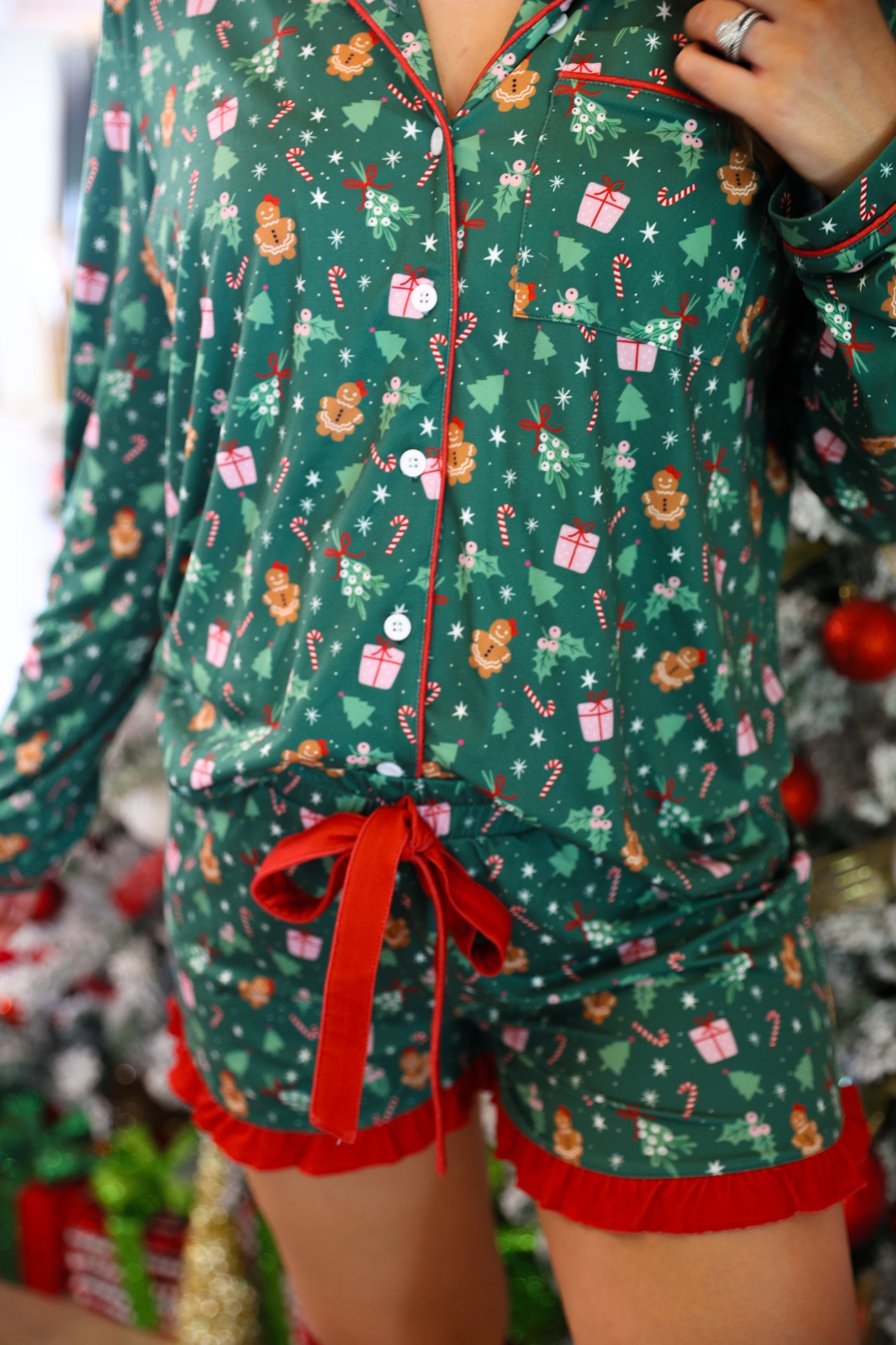 long sleeve top and matching shorts on a custom-designed solid green fabric with a gingerbread girl and a festive holiday print