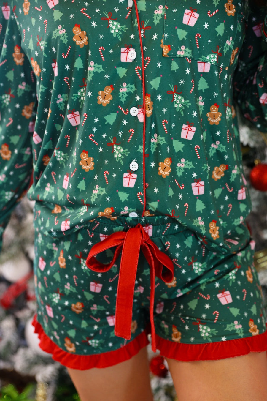 long sleeve top and matching shorts on a custom-designed solid green fabric with a gingerbread girl and a festive holiday print