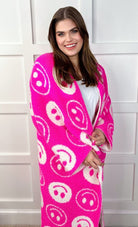 ultra-soft reversible throw on a pink and white happy face pattern print fabric in pink