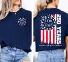 a soft navy unisex Gildan t-shirt with a crew neckline, short sleeves, a front 1776 / 2026 star circle graphic, a bold American flag and 250 YEARS Quarter-Millenial back design, and an easy year-round fit