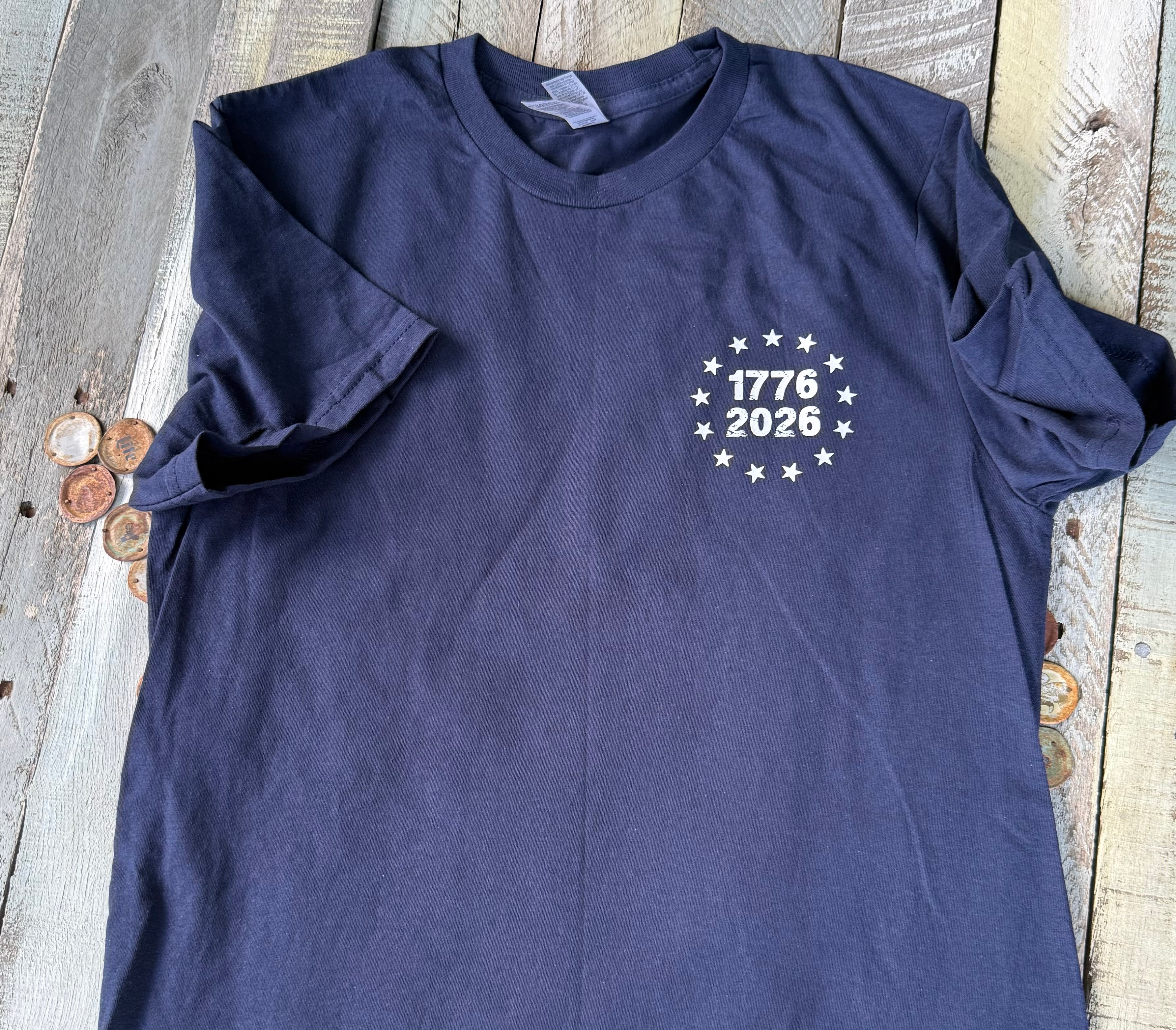 a soft navy unisex Gildan t-shirt with a crew neckline, short sleeves, a front 1776 / 2026 star circle graphic, a bold American flag and 250 YEARS Quarter-Millenial back design, and an easy year-round fit