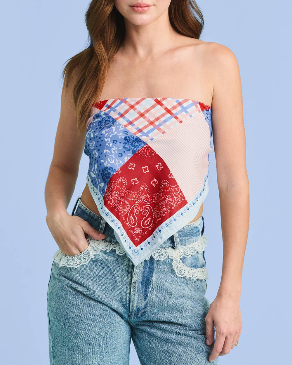 a soft silky polyester scarf with a red, white, and blue quilt-inspired print, finished with a blend of floral, gingham, and paisley details