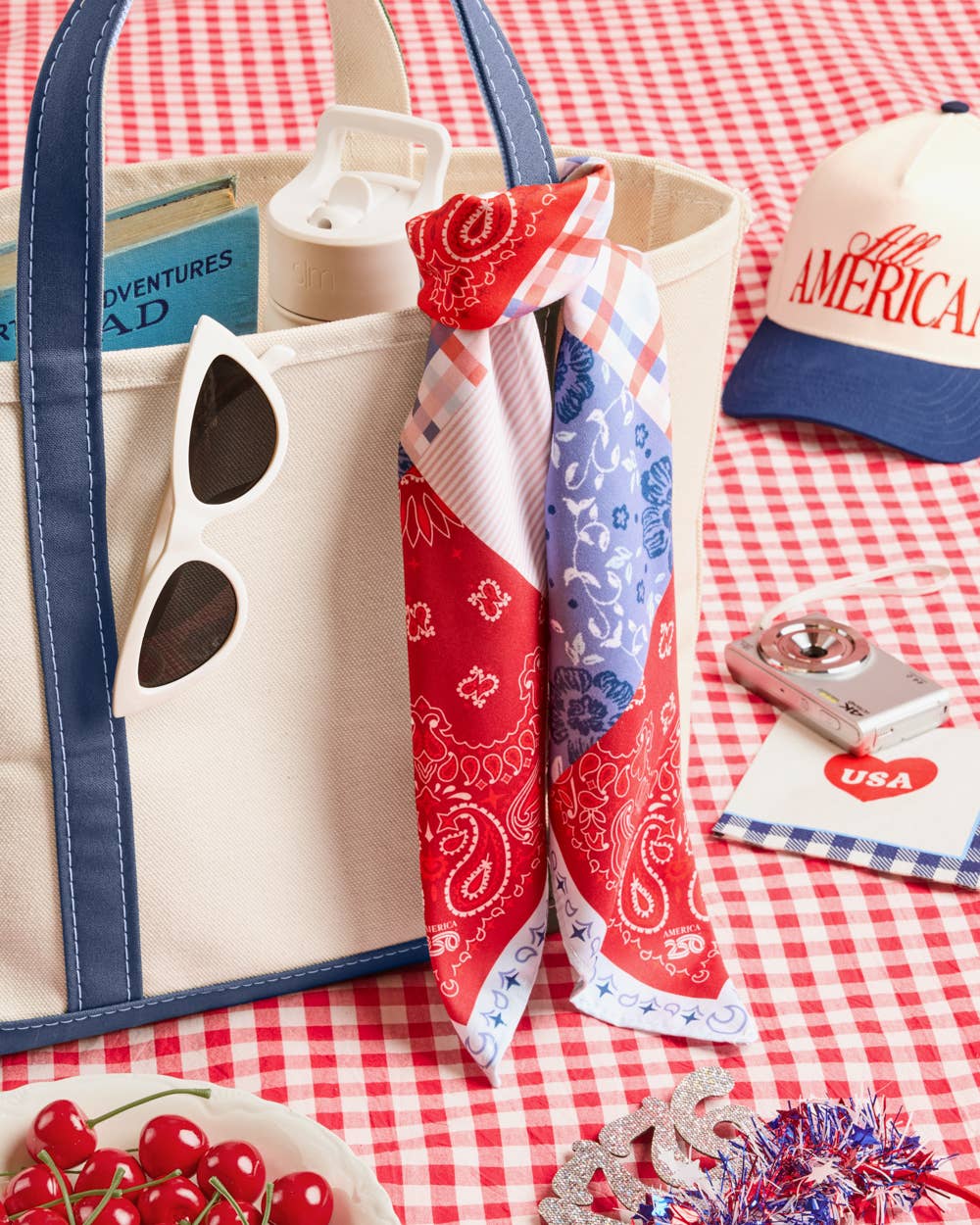 a soft silky polyester scarf with a red, white, and blue quilt-inspired print, finished with a blend of floral, gingham, and paisley details