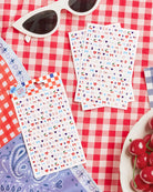 four complete sheets of peel-and-stick nail art with premium CMYK color, iridescent foil, and patriotic icons (bows, cherries, fireworks, flags, hearts, stars, and USA accents)