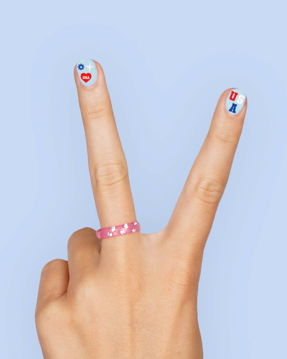four complete sheets of peel-and-stick nail art with premium CMYK color, iridescent foil, and patriotic icons (bows, cherries, fireworks, flags, hearts, stars, and USA accents)