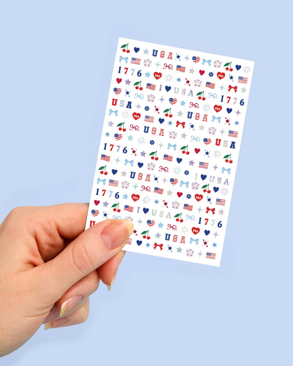 four complete sheets of peel-and-stick nail art with premium CMYK color, iridescent foil, and patriotic icons (bows, cherries, fireworks, flags, hearts, stars, and USA accents)