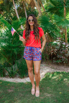 mid-rise, tie waist drawstring with gold bead accent, side pockets, &amp; relaxed fit on a red, white, &amp; blue floral print with blue piping