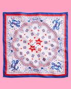 a square bandana with a red, white, and blue western-inspired print, complete with a bold border, cowgirls, hearts, horses, horseshoes, paisley accents, and stars
