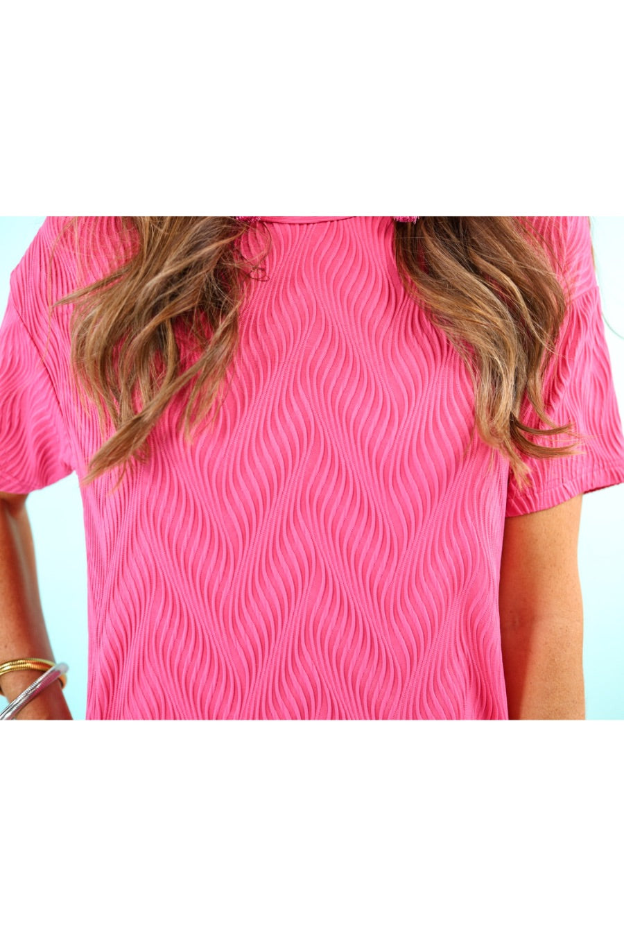 pink short sleeve round neckline textured dress with side pockets and a rounded hemline