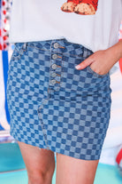 mid-rise two-tone denim checkered print skirt with a little stretch, a button-down fly, five-pocket style, and a distressed hem