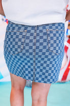 mid-rise two-tone denim checkered print skirt with a little stretch, a button-down fly, five-pocket style, and a distressed hem