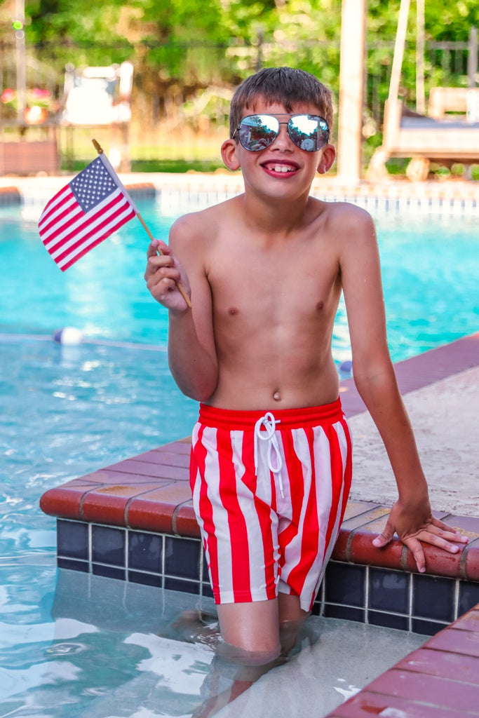 red and white vertical stripe swim trunks with an elastic waistband, drawstring tie, pockets, and built-in mesh underwear